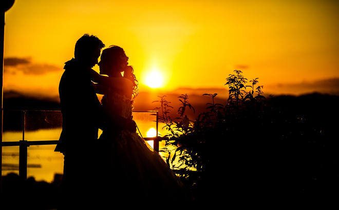 志摩観光ホテルベイスイート屋上にて　英虞湾の夕景をバックに見つめあう新郎新婦